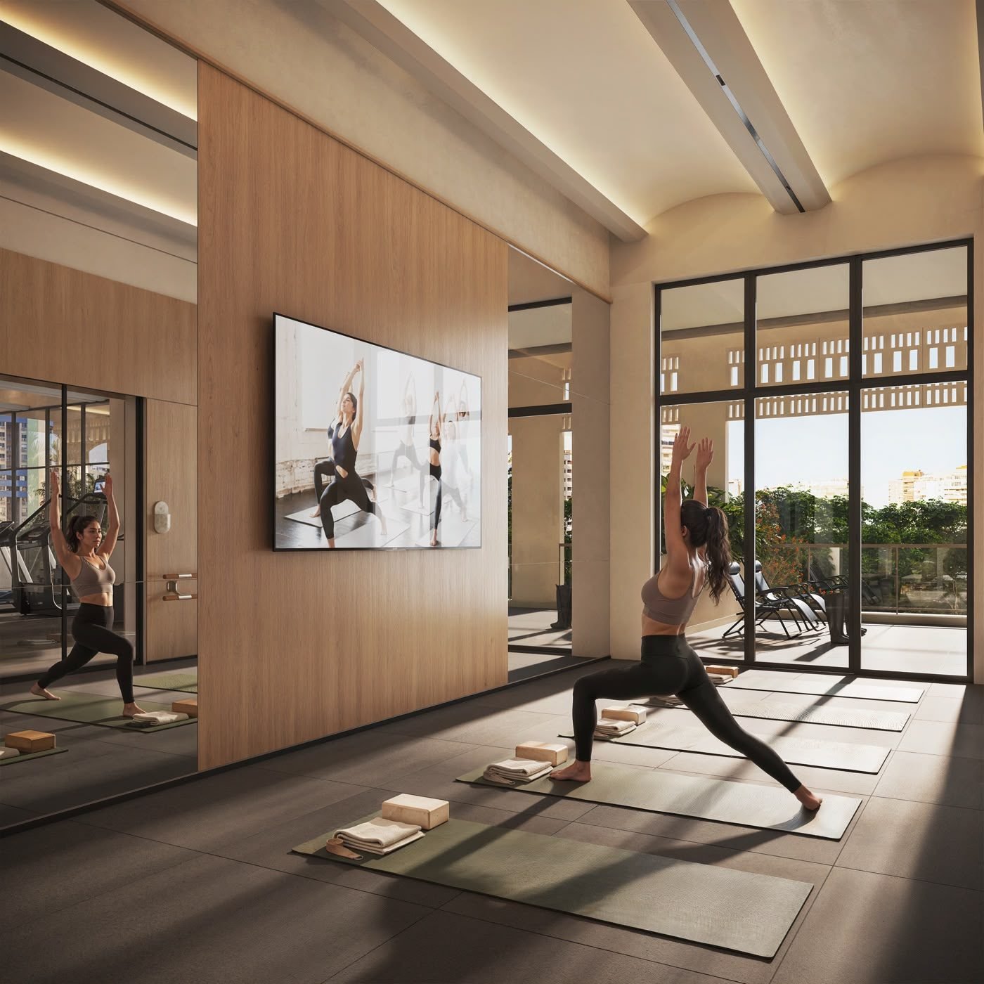 Sala de yoga e pilates do Kronos by Tegra Barra da Tijuca, com espelhos e luz natural